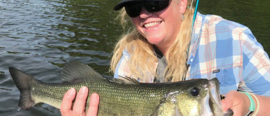 Woman holding largemouth bass.